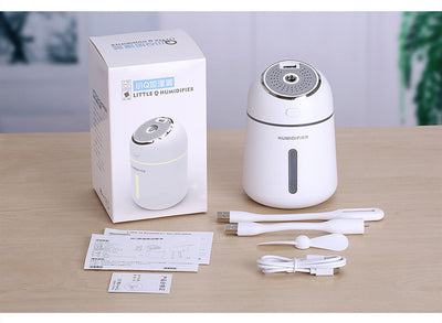 Light blue mini ultrasonic humidifier with a silver top, power button, and clear water level indicator. - Image 8