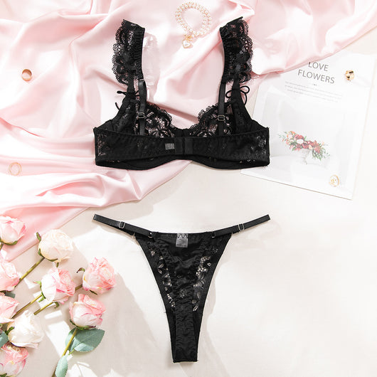 Black sheer lace lingerie set with floral patterns, including an underwire bra and matching thong, on pink satin. - Image 22