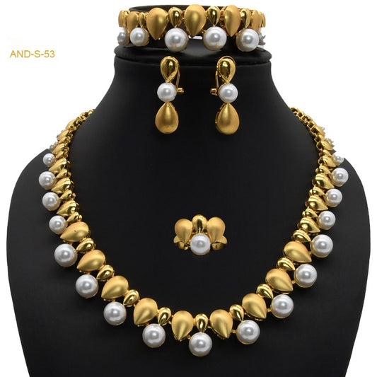 Women's four-piece jewelry set with matte gold teardrop links and white pearls, including a necklace, earrings, ring, and bracelet. - Image 2