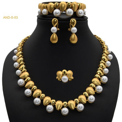 Women's four-piece jewelry set with matte gold teardrop links and white pearls, including a necklace, earrings, ring, and bracelet. - Image 2