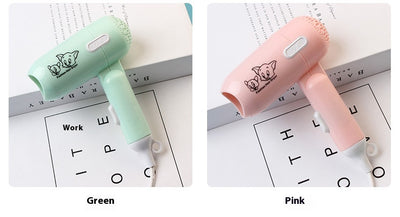 Light blue foldable hair dryer with a cartoon pig design, white power switch, and hanging loop. - Image 13