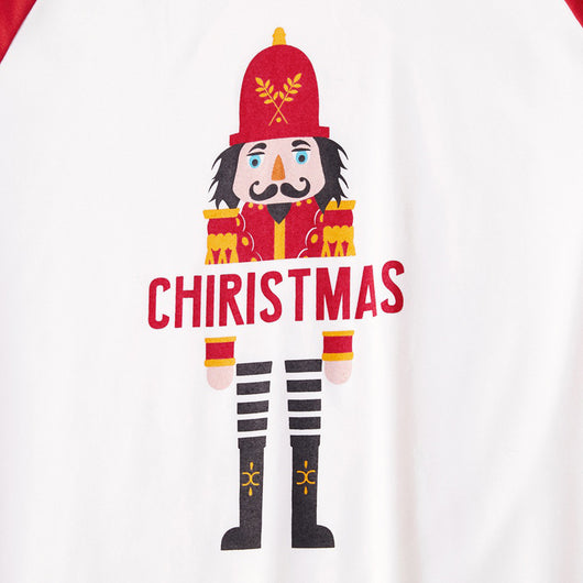 Matching family Christmas pajamas with white raglan tops, red sleeves, and a nutcracker graphic, paired with red, green, and white striped pants. Includes adult - Image 4