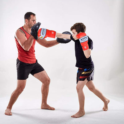 Red and white kids' boxing gloves with "SMASH IT" text, wrist wraps, and a black drawstring bag.