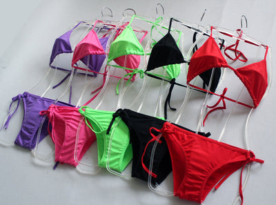 Solid pink two-piece bikini set featuring a triangle top and tie-side bottoms, modeled by a woman by a pool. - Image 15