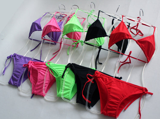 Solid pink two-piece bikini set featuring a triangle top and tie-side bottoms, modeled by a woman by a pool. - Image 15