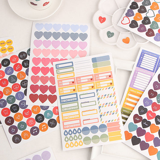 Colorful planner sticker sheet with labels for Scripture Study, Weekly Spending, and Work, featuring various shapes.