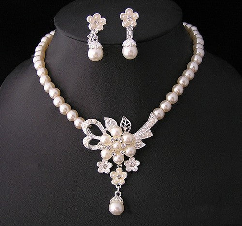 Three-piece pearl jewelry set with multi-strand necklace, bracelet, and drop earrings, all featuring sparkling rhinestone flower accents. - Image 6