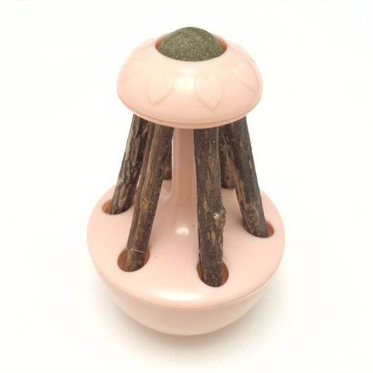 Pink tumbler cat toy with a green catnip ball on top and several natural wooden sticks for chewing. - Image 10