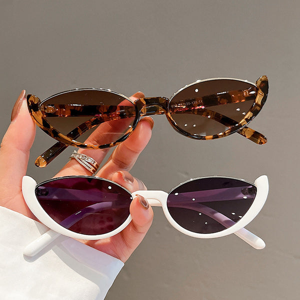 Pink cat-eye sunglasses with purple gradient lenses on a white background, showcasing a trendy style.
