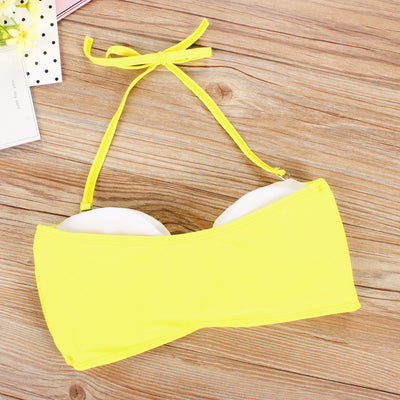 Women's two-piece swimsuit with a solid yellow bandeau top and black high-waisted bottoms with a vibrant abstract geometric pattern. - Image 3