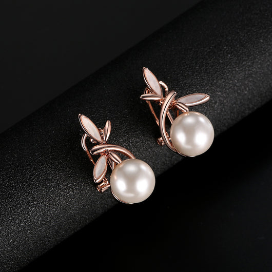 Rose gold-toned necklace and matching earrings set with white pearls and a delicate floral or leaf design. - Image 8
