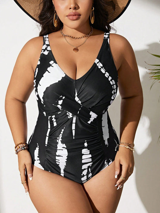 Plus size black and white tie-dye one-piece swimsuit with a V-neck and ruched detailing, worn by a model. - Image 4
