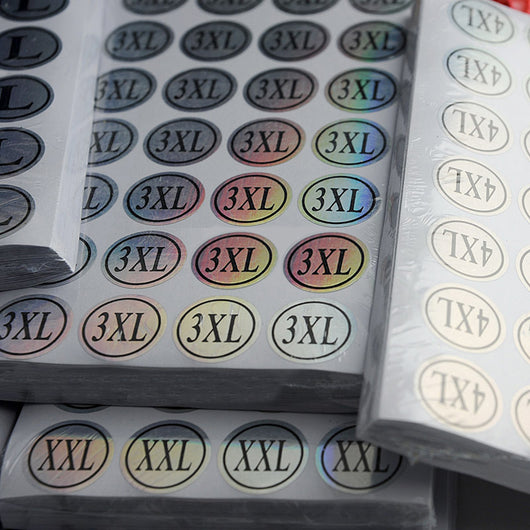 Stack of round clothing size stickers with laser color-changing background and black text, from XS to 4XL. - Image 5