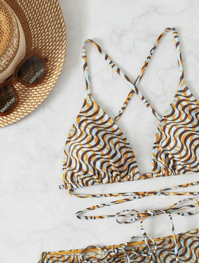 Three-piece swimsuit set with a wavy brown, blue, and white pattern, including a bikini top, mini skirt, and headscarf. - Image 15