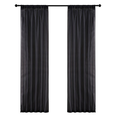 Sheer pink rod pocket curtain hanging on a black curtain rod, offering light transmission for a modern room. - Image 16