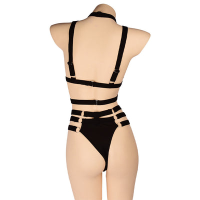 Woman wearing a royal blue strappy lingerie set with O-rings, including a bra, high-waisted bottoms, and a choker. - Image 22