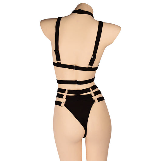 Woman wearing a royal blue strappy lingerie set with O-rings, including a bra, high-waisted bottoms, and a choker. - Image 22