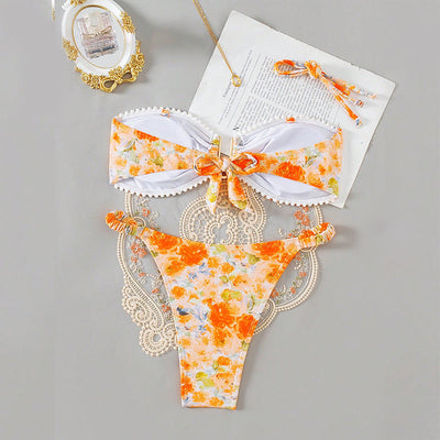 Orange floral print bandeau bikini with pom-pom trim and high-cut thong bottom with side rings. - Image 2