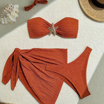 Rust three-piece swimsuit with textured fabric, featuring a tube top with a starfish, high-cut bottoms, and a sarong. - Image 9