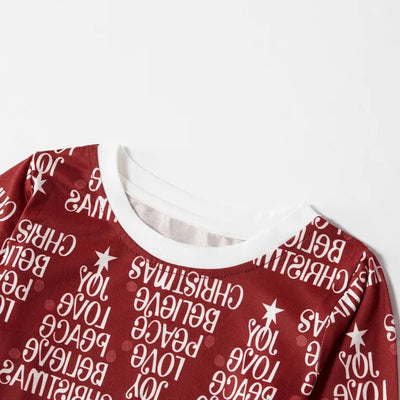 Family of four in matching Christmas pajamas: white tops with red tree graphic, red bottoms with white text. - Image 12