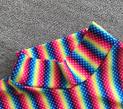 Three-piece rainbow striped bikini suit with triangle top, thong bottom, and long-sleeved cropped cover-up. - Image 9