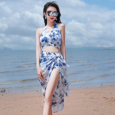 Women's light blue tropical leaf print three-piece swimsuit with short sleeve bikini top, bottoms, and sarong skirt. - Image 2