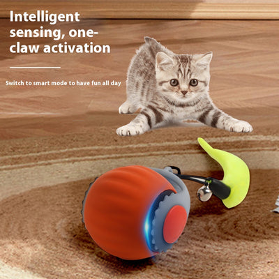 Blue and grey automatic cat toy ball with a yellow feather-like attachment and a small silver bell.