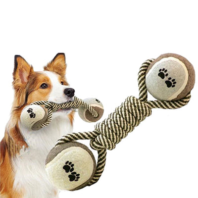 Braided rope dog chew toy with two tennis balls featuring paw prints, shown with a dog holding a similar toy. - Image 5