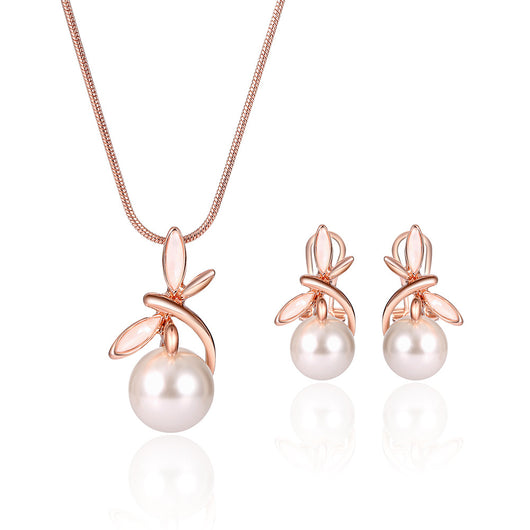 Rose gold-toned necklace and matching earrings set with white pearls and a delicate floral or leaf design. - Image 10