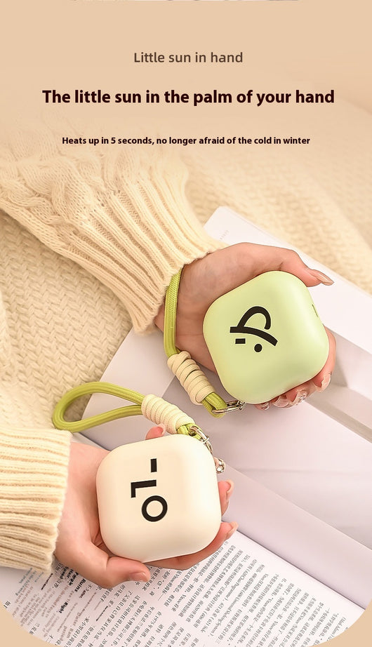 Light green square hand warmer with rounded corners and a black smiley face, hanging from a two-tone lanyard. - Image 15