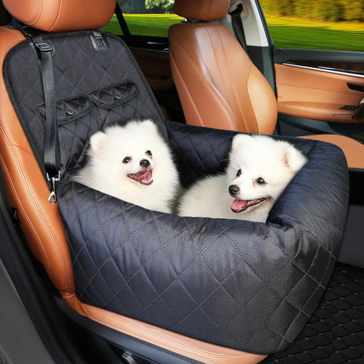 Black quilted pet car seat protector with two happy white fluffy dogs, secured to a brown leather car seat. - Image 10