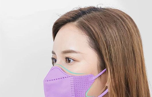 Peach disposable 3-layer face mask with perforated details worn by a person, offering comfortable daily protection. - Image 12