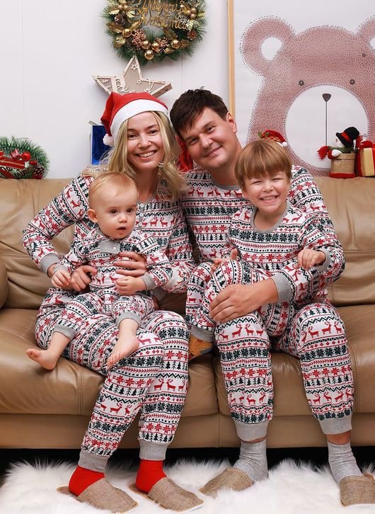 Family of four wearing matching white, red, and green fair isle Christmas pajamas with reindeer and snowflake patterns. - Image 9