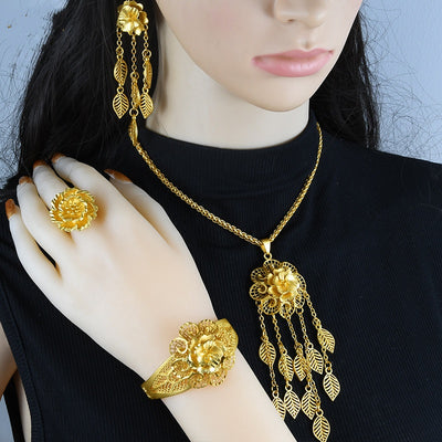 Gold-plated jewelry set with filigree flower designs, including a necklace with dangling chains, matching earrings, a ring, and a bracelet. - Image 10