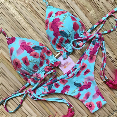 Women's tropical floral print bikini with a halter top, ruffled edges, and tie-side bottoms with pink tassels. - Image 26