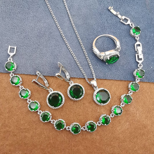 Four-piece silver-tone jewelry set with round green gemstones, including a necklace, bracelet, ring, and dangle earrings. - Image 10