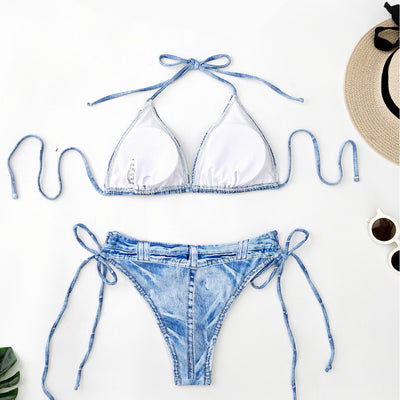 Women's light blue denim print two-piece bikini swimsuit with a halter neck top and tie-side bottoms, styled with a straw hat and sunglasses. - Image 2