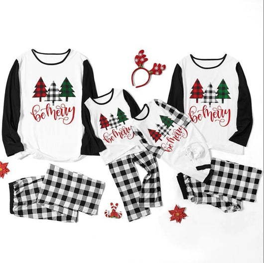 Matching family Christmas pajamas with white tops, black sleeves, buffalo plaid trees, and 'be merry' text. - Image 7
