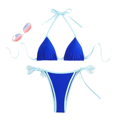 Royal blue two-piece bikini with light blue trim and tie straps, laid flat on a white textured surface. - Image 4