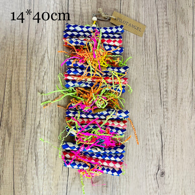 Colorful parrot toy with woven blue, white, and red paper strips, filled with bright crinkly paper, on a wooden background. - Image 11