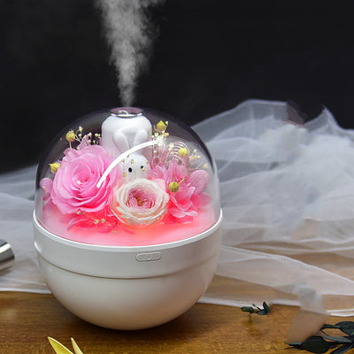 White spherical aroma diffuser with clear dome, featuring preserved blue roses, blue hydrangea, and a white rabbit figurine. - Image 9