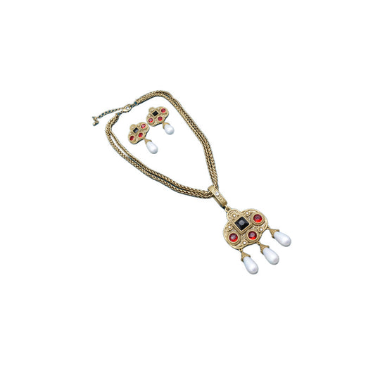Vintage gold-toned necklace with double chain, ornate pendant featuring red and black glass inlays, and three white pearl tassels. - Image 4