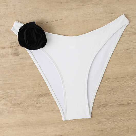 Woman wearing a white triangle bikini with a large 3D flower on the top and a smaller one on the bottom. - Image 18