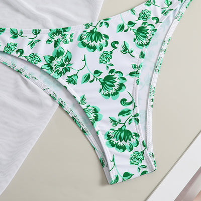 White and yellow floral print three-piece bikini set with a halter triangle top, high-cut bottom, and sheer white sarong. - Image 19