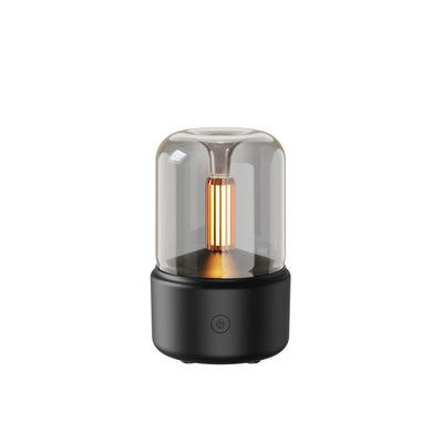 White cylindrical aroma diffuser with a clear top and an amber candlelight-effect LED light. - Image 14