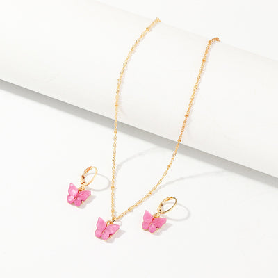 Blue resin butterfly necklace and earring set with gold-tone chains and findings, displayed on a light background. - Image 12