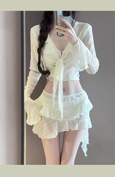 White four-piece bikini swimsuit set for women, featuring a long-sleeve tie-front top and tiered ruffle skirt. - Image 9