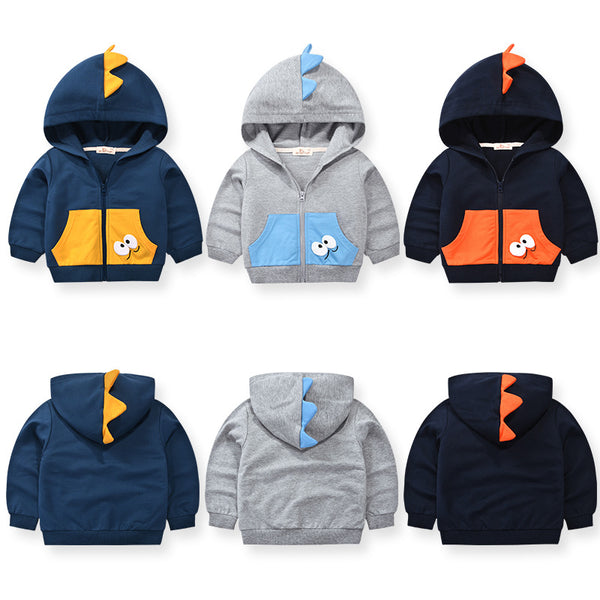 Navy blue children's hooded jacket with orange dinosaur spikes on the hood and googly eyes on the front pocket.