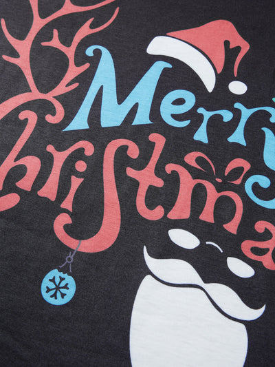 Man wearing a black and red long-sleeve Christmas pajama set with "Merry Christmas" graphic and Santa print pants. - Image 22