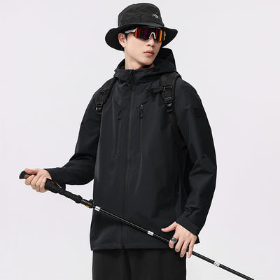 Man wearing a black windproof and waterproof outdoor jacket with a hood, sports sunglasses, and a bucket hat, holding a trekking pole. - Image 6